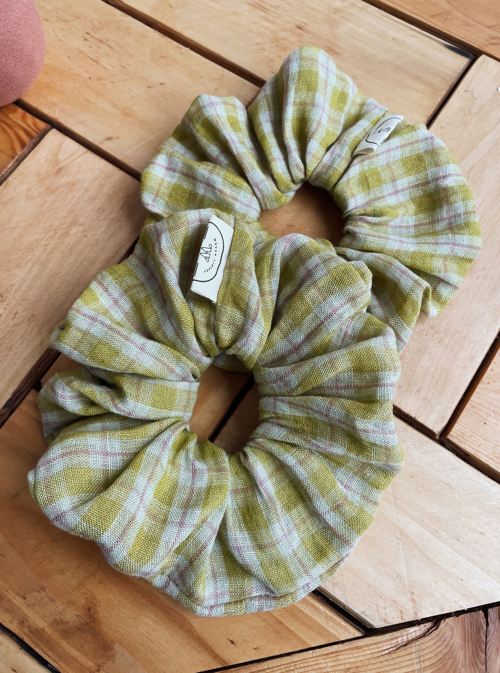 Plaid fabric scrunchie on a wooden surface