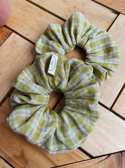 Plaid fabric scrunchie on a wooden surface