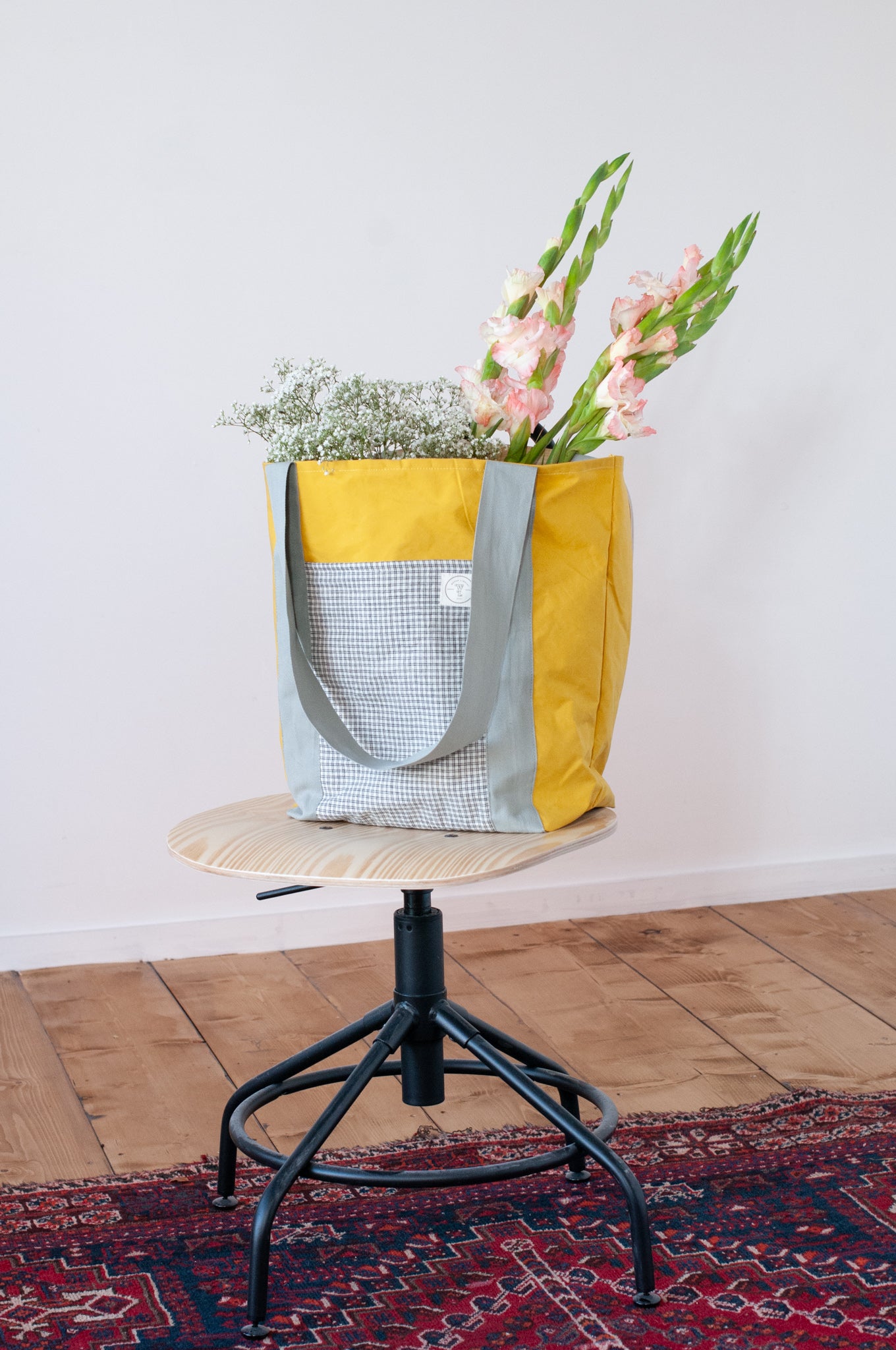 Yellow bag with check pockets and grey straps made from dry oilskin cotton